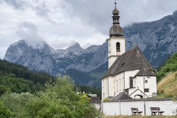 Fototapeta na wymiar Old traditional church in alpine environment with mountains in background, Hintersee, Germany