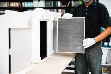 Technician open cover to fix and holding dirty and dust air purifier filter for removing and...