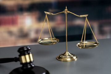 Shiny golden balanced scale and wooden gavel in law firm or lawyer office background as concept...