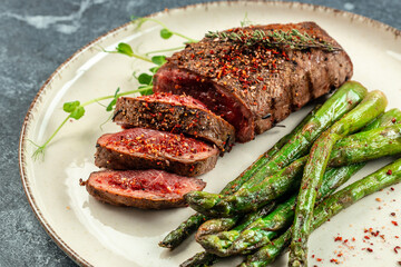Barbecue steak with green asparagus and red wine. Healthy dinner or lunch