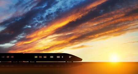 High speed train silhouette in motion at sunset. Fast moving modern passenger train on railway platform. Commercial transportation.