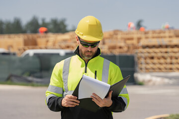 Fototapeta premium Portrait of american worker in construction helmet. Engineer builder foreman or repairman. Worker at building site. Construction manager in helmet. Male construction engineer. Handyman in hardhat.