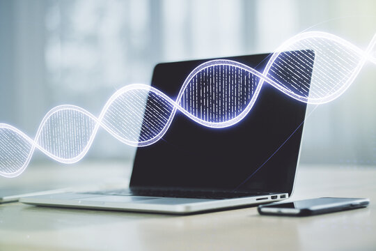 Double exposure of creative DNA hologram on laptop background. Bio Engineering and DNA Research concept