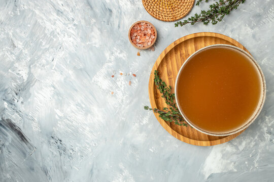 Bone meat chicken broth in a bowl on a light background, banner, menu, recipe place for text, top view