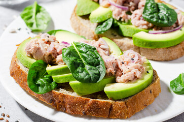 Fototapeta na wymiar Tuna Avocado Toasts, Healthy Snack or Breakfast on Bright Background