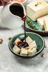 soy cheese tofu diced on a light background, Healthy vegan meatless meal rich in protein and calcium. Food recipe background. Close up