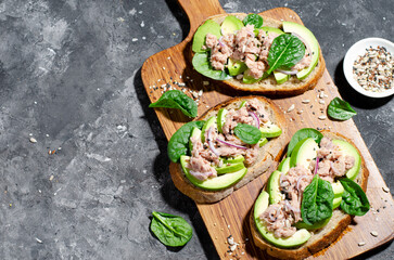 Tuna Avocado Toasts, Healthy Snack or Breakfast on Dark Background