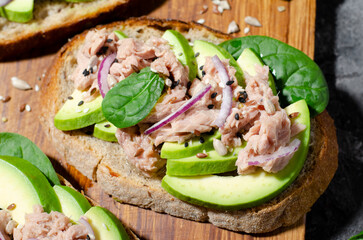 Tuna Avocado Toasts, Healthy Snack or Breakfast on Dark Background