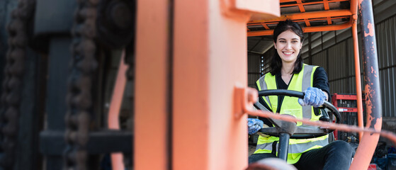 Portrait of a woman working with a forklift in a warehouse. Concept industrial and commercial.