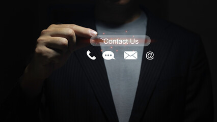 Contact us or Customer support concept. Pen tapping on a virtual screen of contact icons: phone,...
