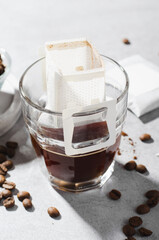 Obraz na płótnie Canvas Drip Coffee Bag in a Cup, Coffee Trend, Quick Way to Brew Ground Coffee