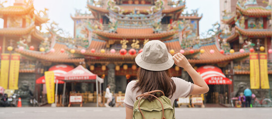 woman traveler visiting in Taiwan, Tourist sightseeing in Songshan Ciyou Temple, near Raohe Night Market, Songshan District, Taipei City. landmark and popular. Travel and Vacation concept