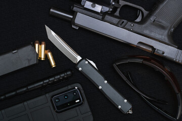 Tactical equipment, folding knife, pistol, pen, cartridges and more.