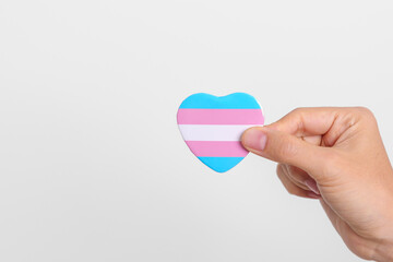 Transgender Day and LGBT pride month,  LGBTQ+ or LGBTQIA+ concept. hand holding blue, pink and...