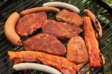 various meat and sausages on the charcoal grill