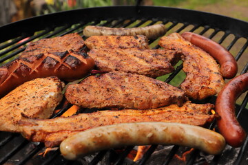 various meat and sausages on the charcoal grill