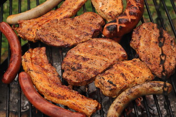 various meat and sausages on the charcoal grill