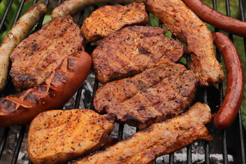 various meat and sausages on the charcoal grill