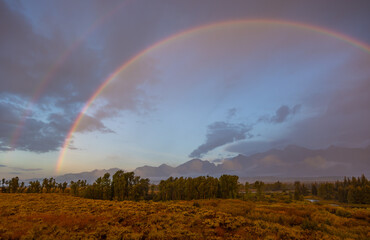 Fototapeta na wymiar Autumn Landscape in the Tetons in a Storm with Rainbow