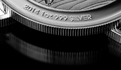 Close up of  Silver Bullion Coin on a black mirror background