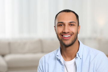 Portrait of smiling African American man at home. Space for text