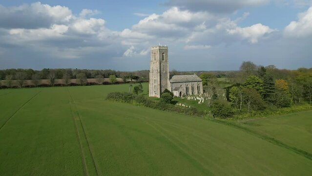 Honing, Norfolk, UK &ndash; April 22 2023. Aerial push in footage towards the church of St Peter and St Paul in the village of Honing in the Norfolk countryside