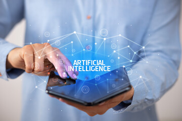 Businessman holding a foldable smartphone, new technology concept