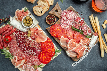 Cold meat plate Italian snacks food with ham, prosciutto, salami, pork chops, sausage and grissini bread sticks, catering banner, menu, recipe