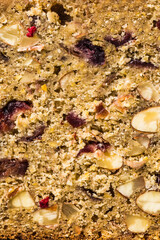 Whole grain bread with nuts and berries close-up. Macro concept of healthy pastries and natural products