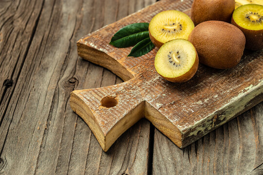 Closeup ripe golden kiwi fruit on wooden background. Healthy fruits concept. place for text, top view