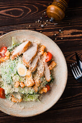 Italian Caesar salad with chicken, parmesan cheese, lettuce, eggs, tomatoes and croutons.