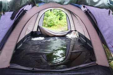 A puddle inside a bad tourist tent after a rainstorm. The choice of equipment for hiking and...