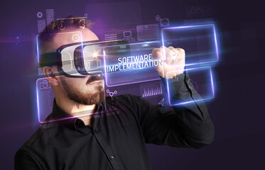 Businessman looking through Virtual Reality glasses, tech concept