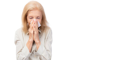 Ill woman runny nose sneezes into tissue Flu allergy Sick old lady sneezing in tissue Senior...