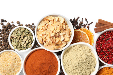 Bowls with different spices on white background, top view
