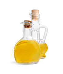 Glass jugs of cooking oil on white background