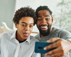 father son family smartphone teenage phone parent selfie fun portrait happy camera boy man child photography smiling cheerful self taking technology together