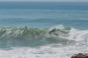 Surfer generating spray in Anchor Point, Morroco