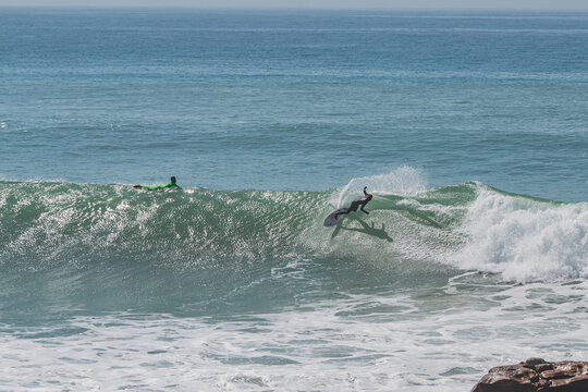 Surfer generating spray in Anchor Point, Morroco