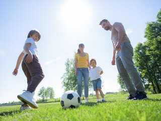 Parents and kids play soccer