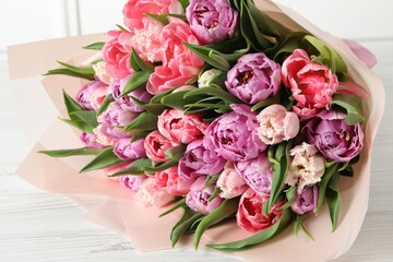 Bouquet of beautiful tulips on white wooden table, closeup