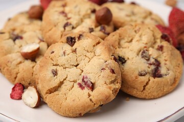 Cookies with freeze dried fruits and nuts on white plate, closeup