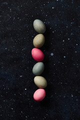 Dyed eggs on black background. Easter celebration concept
