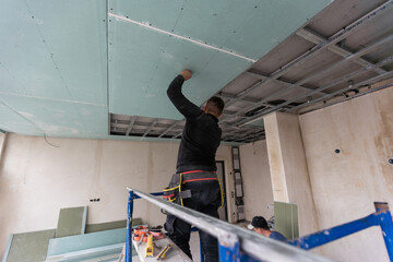 Construction worker installation ceiling work