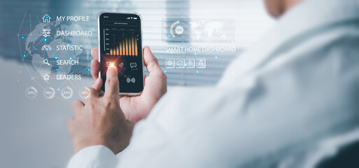 Men use mobile phones to control smart home devices and introduce the concept of smart home in the white living room.