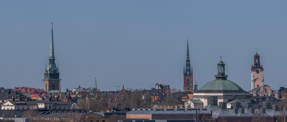 Fototapeta premium Panorama, roofs and church towers in the old town Gamla Stan. a sunny spring day in Stockholm