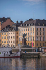Fototapeta na wymiar The statue monument of King Gustav III on the pier Stadsgårdskajen, a tranquil early sunny spring day in Stockholm