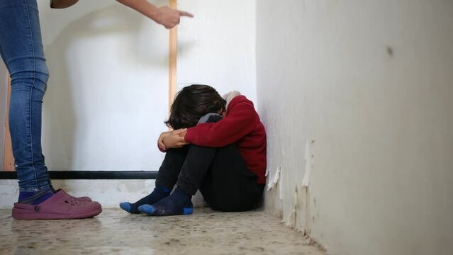 domestic violence. little boy with bruises and abrasions autistic on her face punished in the corner crying tears. domestic child abuse fear concept. child is punished and beaten afraid of fear