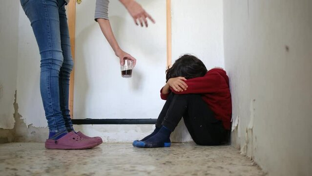 domestic violence. little boy with bruises and abrasions autistic on her face punished in the corner crying tears. domestic child abuse fear concept. child is punished and beaten afraid of fear