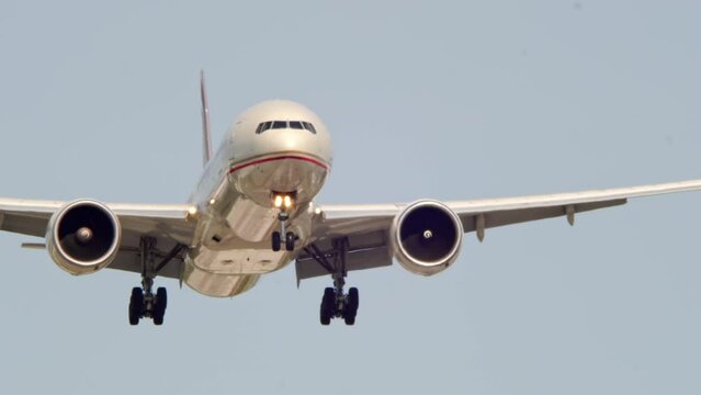 Airplane landing overhead at Canadian airport. Passenger flight arriving and descending. Front bottom view of aircraft flies and approaching.